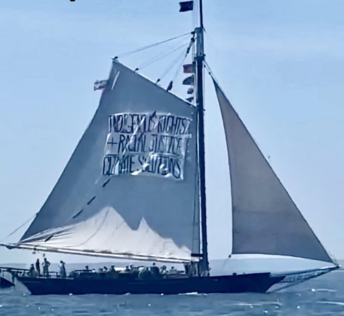 Sailboat with sign on sail:
Indigenous rights
Racial justice
Climate solutions