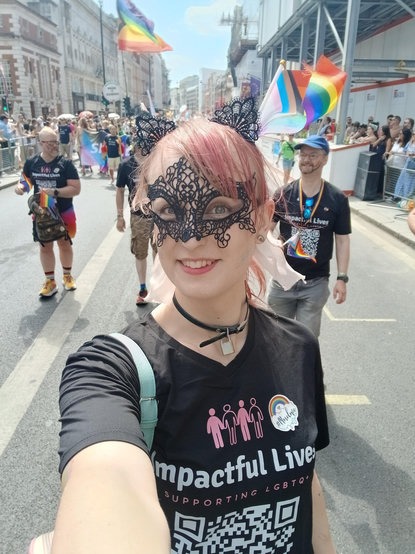May takes a selfie as she marches down a street in London as part of the Pride parade 