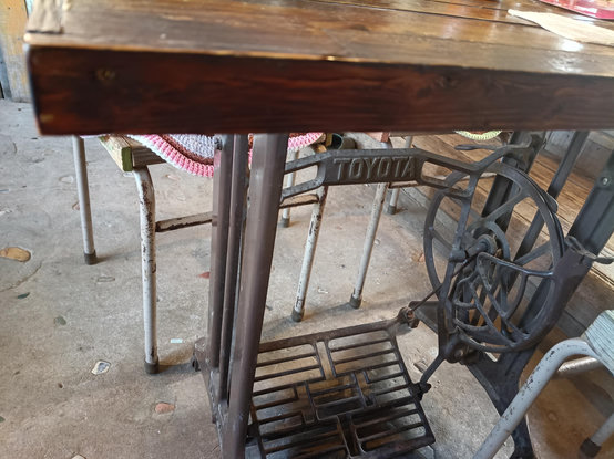 The mechanism under a table adapted from a Toyota treadle-driven sewing machine.
