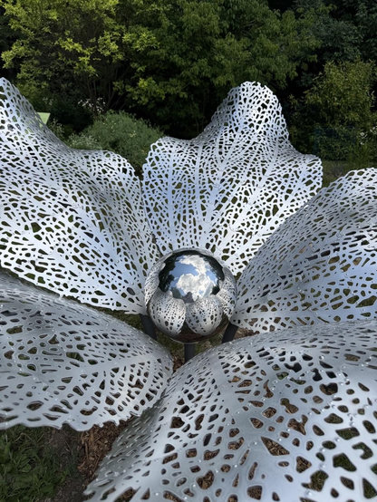 Cloud Flora installed at Hortus. It’s a silver flower with a mirror ball reflecting the sky in the center 