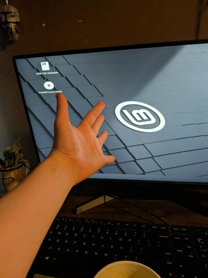my hand out stretched in front of linux mint desktop