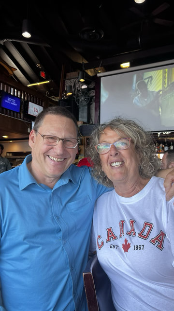 Avi Lewis taking a picture with someone wearing a Canada shirt.