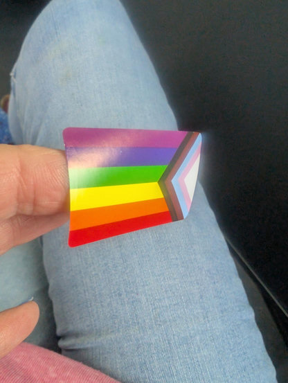 Gay flag sticker on my finger ready to stick