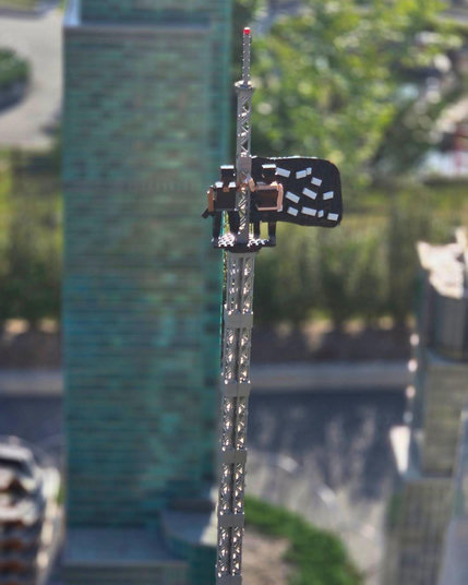 A close up of the tiny figures against other New York skyscrapers in the background.