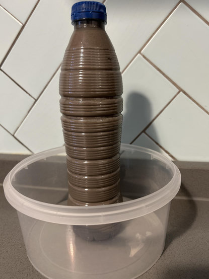 Plastic bottle with grey liquid 