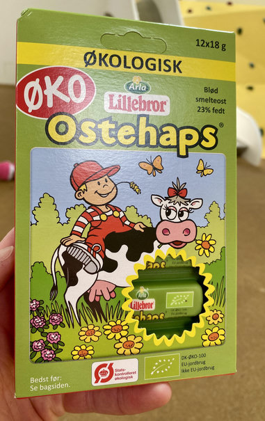 Ostehaps packaging. A kid sitting on a romanticised cow. Kid has massive feet btw.