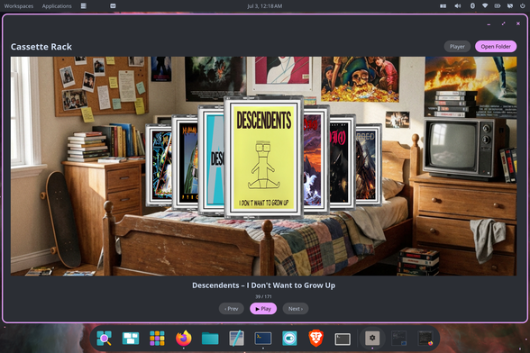 A desktop application titled "Cassette Rack" displaying a 3D carousel of classic cassette tape cases. The center tape is the Descendents album "I Don't Want to Grow Up." The background of the app is a nostalgic, retro bedroom scene featuring a skateboard, an old CRT television, books, and band posters on the wall. Below the cassette carousel are navigation buttons, a play button, and text showing this is tape 39 out of 171. The application is running on a Linux desktop environment with a bottom dock.