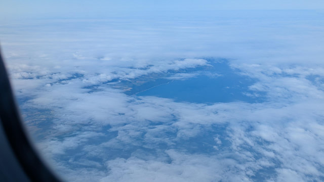 Looking down through a gap in the clothes the North Devon coast can be seen, the seven estuary heading out towards the Irish sea and Atlantic 

Take from a loganair flight from Manchester to Exeter