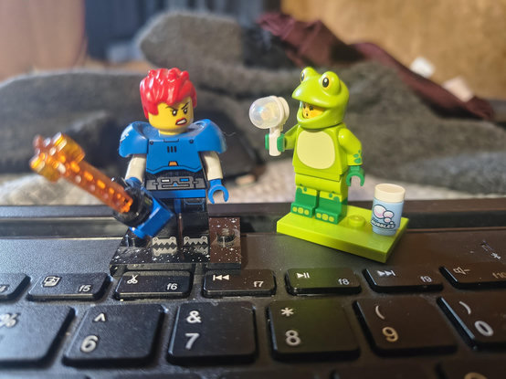 The frog minifig is blowing bubbles to annoy laser chainsaw space warrior minifig and wow she looks pissed