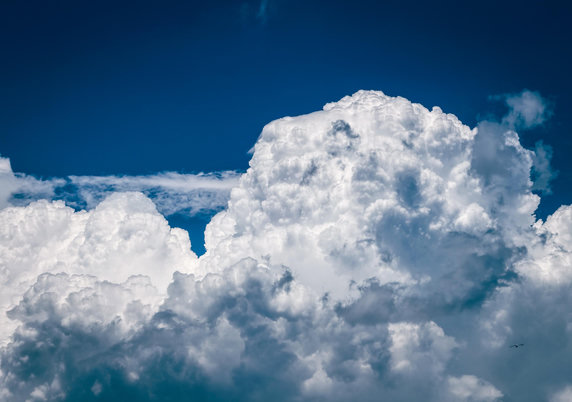 Large white fluffy clouds in a dark blue sky