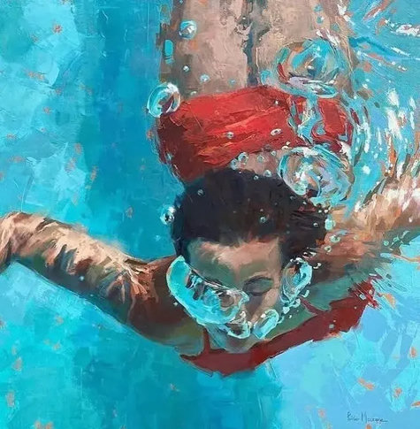 A female swimmer wearing a red swimsuit, completely submerged underwater with air bubbles surfacing.