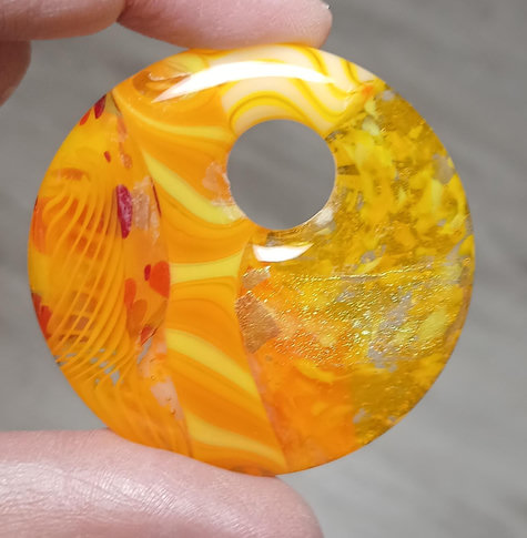 another round pendant much like the previous with more dichroic and the components arranged differently
