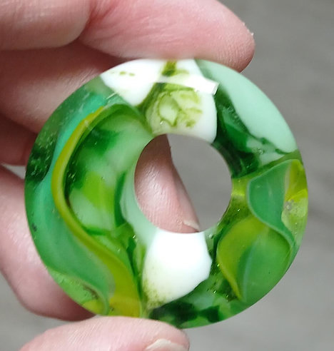 green and white pendant that looks like sea grass