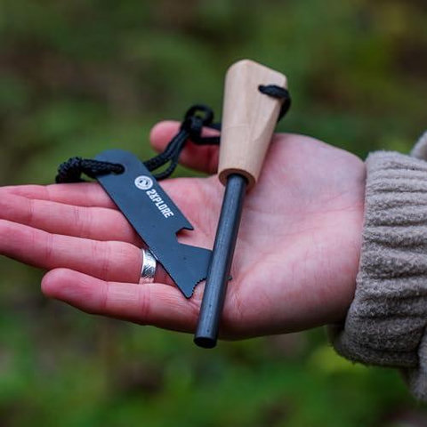 Stock image of a hand holding a flint and steel fire starter