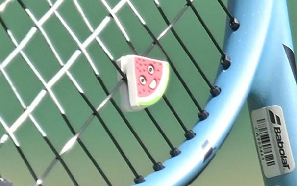 Zeynep's racket with a watermelon badge 