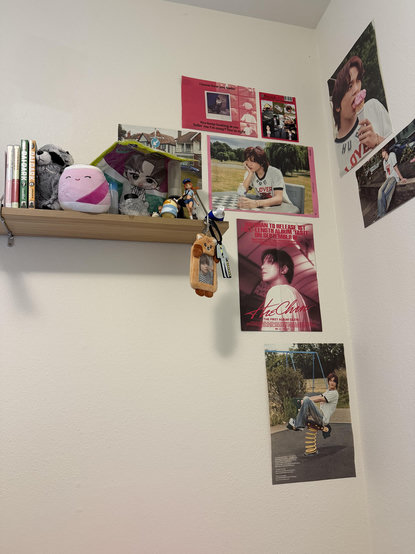 the corner of a room with posters of a kpop idol