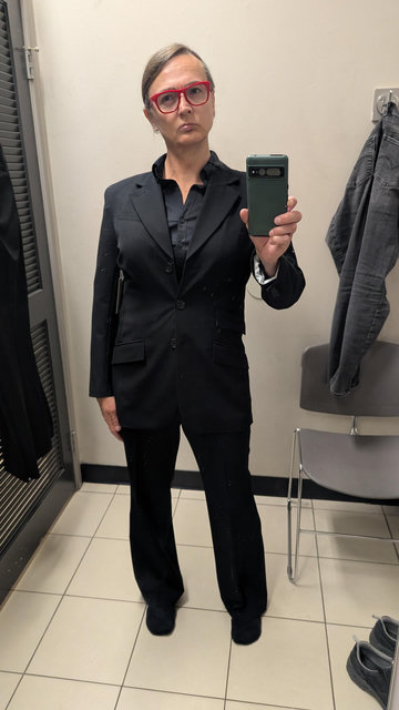 photo of Coleen in a black on black suit sans vest
