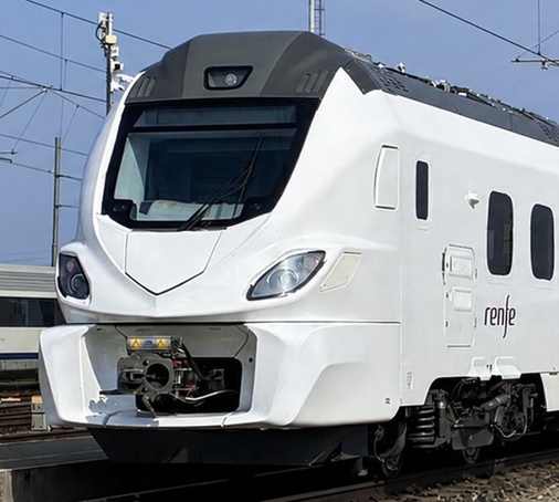 A white train for Renfe on the testing track in Czechia. The coupler box is very wide and the front lights are very pointy.