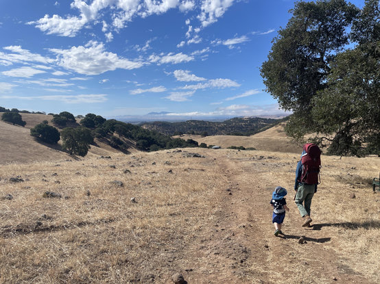 A woman and kid in scrubby brown california landscape; Mt Diablo in the background