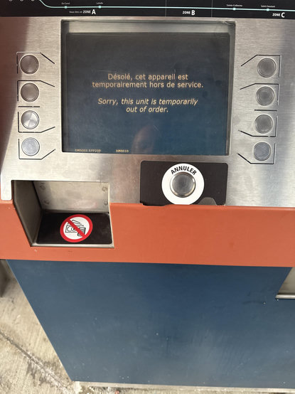 Photo of a legacy Montréal fare vending machine displaying “Sorry, the unit is temporarily out of order”