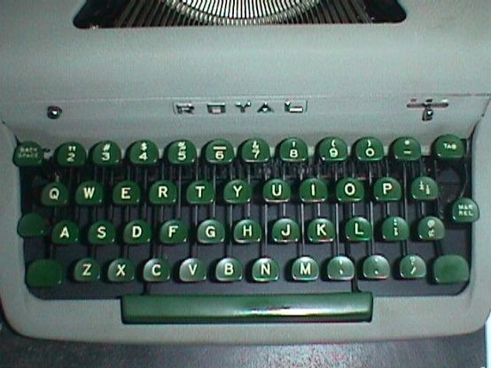 The keyboard. It has all the English letter keys, the number keys 2 through 0, hyphen-minus, semicolon, comma, period, and slash keys in their Standard/Qwerty positions.

However, the number 1 and exclamation point key is missing, and the shifted characters of the comma and period keys are also the comma and period, not the less-than ("<") and greater-than (">") characters on computer keyboards. The special keys are the half and quarter key right of P and the cent sign key right of semicolon.

Photo taken with a 1998 Sony Mavica MVC-FD51 camera with flash on.