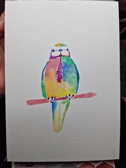 Blue tit, a normally small yellow and blue bird, but painted in rainbow colours