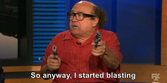 A man with glasses and a red shirt appears to be animatedly talking while holding a prop gun in each hand. The text below him reads, "So anyway, I started blasting." The setting looks like a talk show environment.