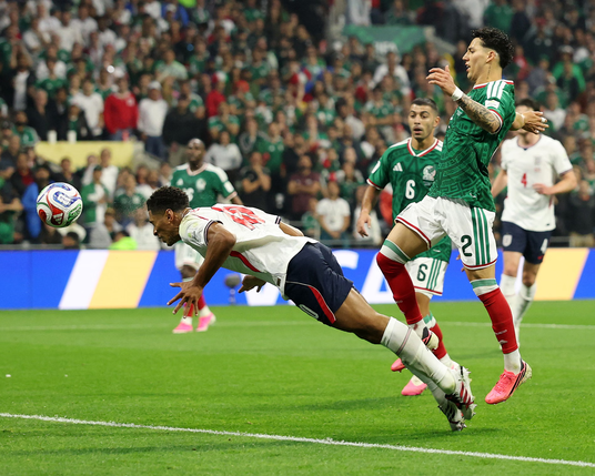 Jude Bellingham heads in from Saka’s cross.
Photograph: Michael Steele/Getty Images