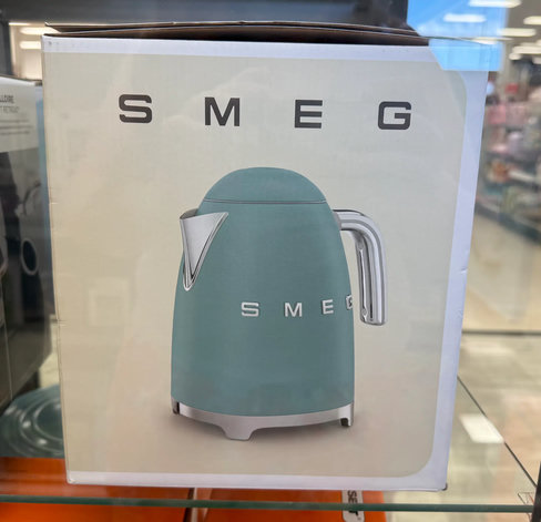 A boxed kettle in a light blue colour by the brand name, "Smeg"