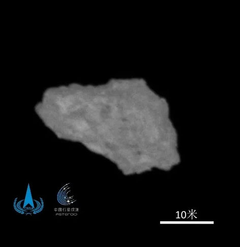 An image of asteroid Kamo'oalewa seen from 20 km away.  It looks like a tiny crumbly piece of concrete rock, but it's actually 18m across.
From: https://www.xinhuanet.com/20260706/eb8cbec6dfc94a0c84a24e6940334f1d/c.html